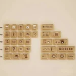 Close-up of the Programmer Coffee PBT Dye-Sub Keycap Set showcasing its unique coffee shop and coding motifs from various angles, creating a cozy dev desk.