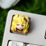 Close-up of the whimsical handmade resin biscuit mouse keycap, showcasing its adorable design and glossy finish from a unique side angle.