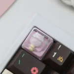 This whimsical pig ice cream artisan resin keycap is handcrafted, featuring a charming miniature design with vibrant colors.