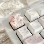 Close-up view of the whimsical rocking horse angel baby artisan keycap, showcasing its intricate details and dreamlike artistry from a unique angle.