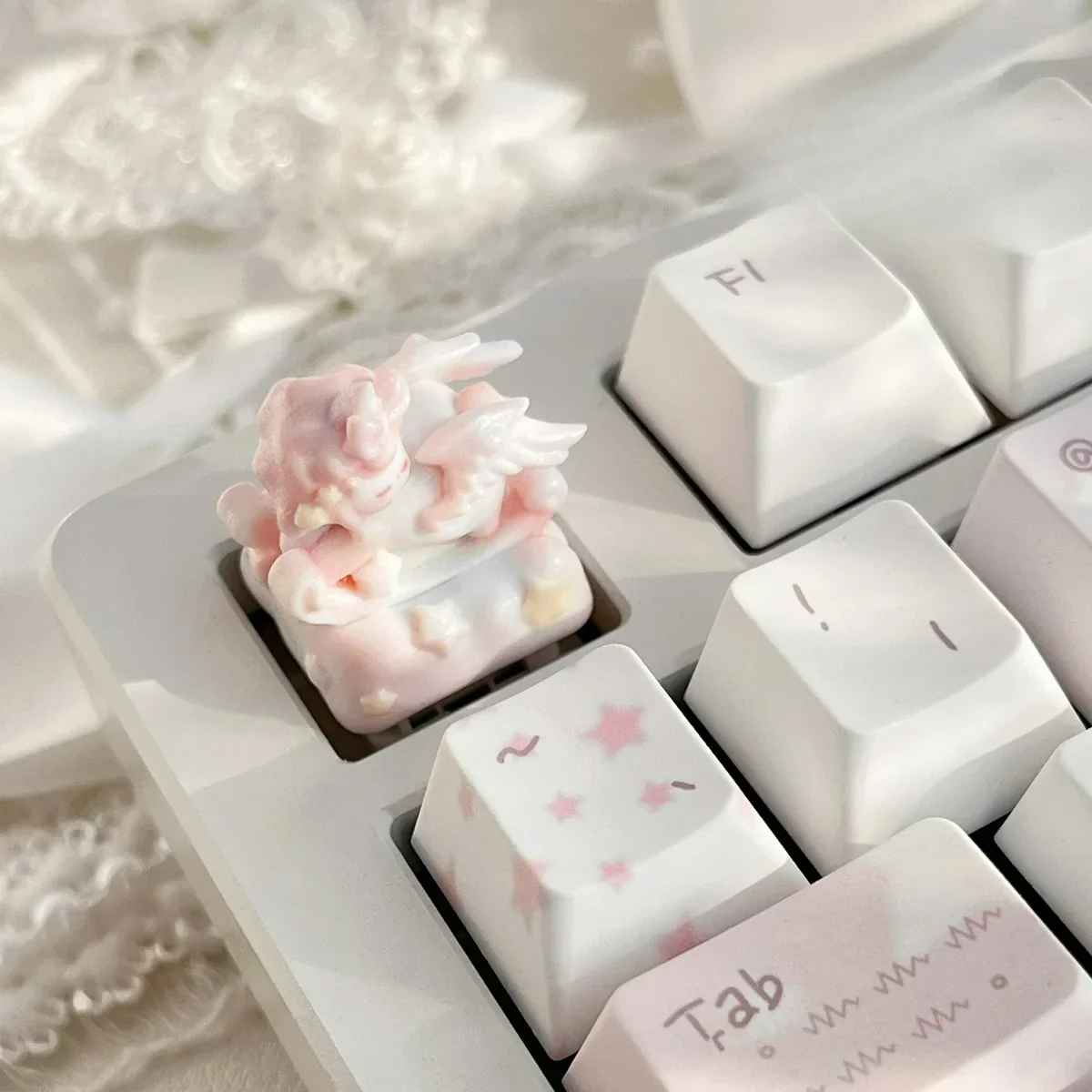 Close-up view of the whimsical rocking horse angel baby artisan keycap, showcasing its intricate details and dreamlike artistry from a unique angle.