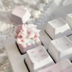 An enchanting side view of the whimsical rocking horse angel baby artisan keycap, showcasing the delicate angelic figure and intricate details.