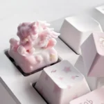 Dreamlike artisan keycap showcasing a whimsical rocking horse and angel baby design, an artistic piece evoking serene childhood memories.