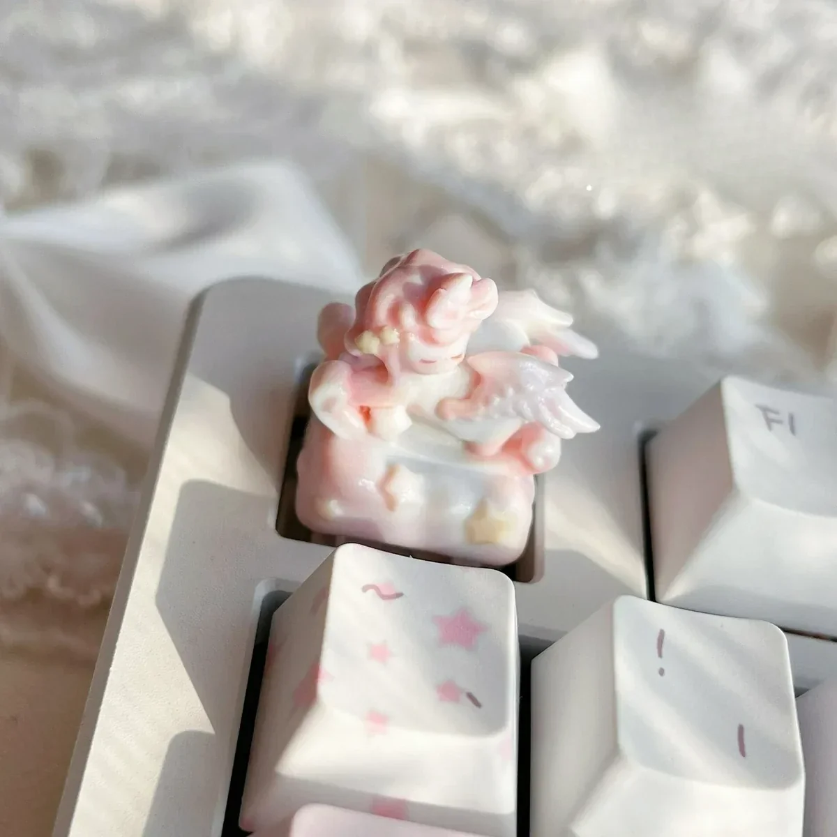 An artistic artisan keycap showcasing a whimsical angel baby on a rocking horse, evoking serene childhood memories with its delicate, dreamlike details.