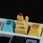 Artisanal 3D sandcastle resin keycap, intricately sculpted and showcased from various angles, evoking serene beach joy and childhood dreams.