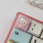 Close-up of a handcrafted Sanrio pajama ESC keycap, showcasing adorable characters in cozy pajamas with a vibrant resin finish, perfect for a charming design.
