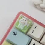 Adorable handcrafted Sanrio pajama ESC resin keycap showcasing cozy characters and a vibrant epoxy finish, perfect as a charming desk accent.