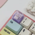 Adorable handcrafted resin ESC keycap featuring Kuromi in cozy pajamas, a playful Sanrio desk accent with vibrant epoxy finish.