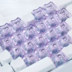 Close-up of adorable translucent Sanrio character MAO profile Supplement Keycap Set, showcasing pastel heart accents and vibrant backlight glow from a different angle.