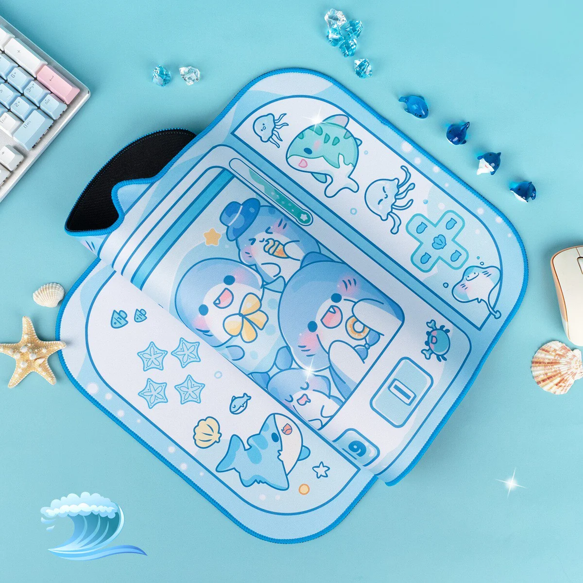 Angled view of the XL Whimsical Shark Claw Machine Desk Mat, highlighting its playful arcade design with adorable sharks and the smooth, comfortable material.