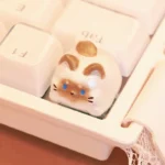 Charming handcrafted Siamese cat keycap, an unique artisan keyboard art piece featuring an intricate, whimsical Siamese kitten design.