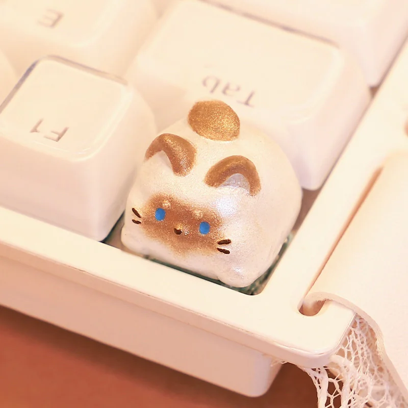 Charming handcrafted Siamese cat keycap, an unique artisan keyboard art piece featuring an intricate, whimsical Siamese kitten design.