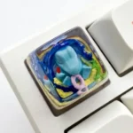 Close-up of a vibrant, unique handcrafted Totodile Pokemon SA keycap, meticulously sculpted from high-quality resin, perfect for collectors.