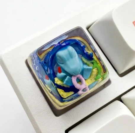 Close-up of a vibrant, unique handcrafted Totodile Pokemon SA keycap, meticulously sculpted from high-quality resin, perfect for collectors.