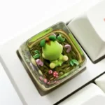 Vibrant, handcrafted resin Pokemon Turtwig SA keycap glowing with keyboard backlighting, showcasing intricate artisan detail.