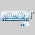 Unique Snowflake Seal PBT Dye-Sub Keycaps set, artistically showcasing its charming blue gradient and whimsical snowflake motifs from a distinct angle.