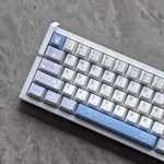 Sora Kasugano PBT Dye-Sub Keycap Set shown from multiple angles, featuring exclusive waifu artwork and a playful white/black anime design.