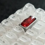 Luminous Sorcerer's Stone artisan keycap. See its mystical glow from various angles. A captivating Wizarding World backspace.