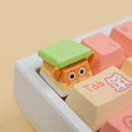 A playful, detailed view of the iconic Peeking Sandy Cheeks artisan SpongeBob keycap, showcased from a slightly elevated angle to highlight its vibrant.