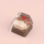 Detailed view of a whimsical handcrafted dessert keycap, highlighting its miniature, realistic sweet pastry design and charming artistic appeal for keyboard.