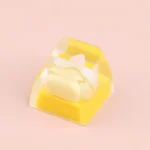 Close-up of a whimsical handcrafted dessert keycap, revealing its intricate miniature sweet design from a delightful angle. An irresistible keyboard.