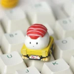 Artistic close-up of a vibrant handcrafted resin sushi cat artisan keycap for ESC, showcasing its intricate details and playful design from multiple angle.