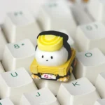 Close-up of a vibrant, handcrafted resin Sushi Cat Artisan Keycap for ESC, showcasing its intricate details and artistic design from a unique angle.