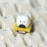 Handcrafted resin sushi cat artisan keycap for ESC, displayed from a unique angle, showcasing its vibrant colors and intricate, whimsical details.
