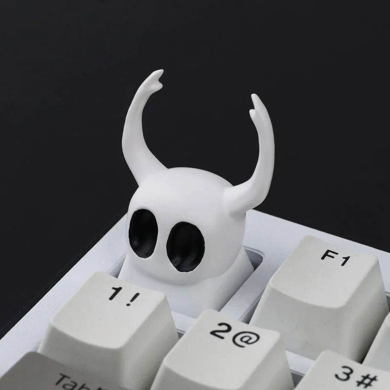 A collection of Hollow Knight The Knight artisan resin keycaps, handcrafted with exquisite dark fantasy detail, shown from various angles.