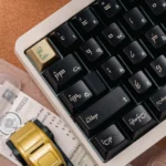 Black-gold PBT keycaps set, multiple angles highlighting their unique luxurious finish. Dark, mythical elegance and premium metallic sheen.