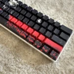 Close-up of Tokyo Ghoul Ken Kaneki side-lit PBT keycaps set showcasing the dark, mysterious anime aesthetic and subtle glowing legends from a unique angle.