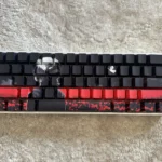 Exclusive close-up of Tokyo Ghoul Ken Kaneki PBT keycaps set, showcasing their mysterious side-lit legends and dark anime aesthetic.