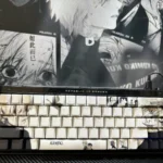 Artistic close-up of Tokyo Ghoul side-printed shine-through PBT keycaps set, showcasing dark anime aesthetic and illuminated legends from various angles.