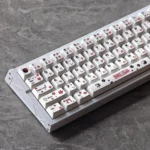 A vibrant Touhou Reimu Hakurei PBT dye-sub keycap set displayed from multiple artistic angles, showcasing the iconic anime art and durable quality.
