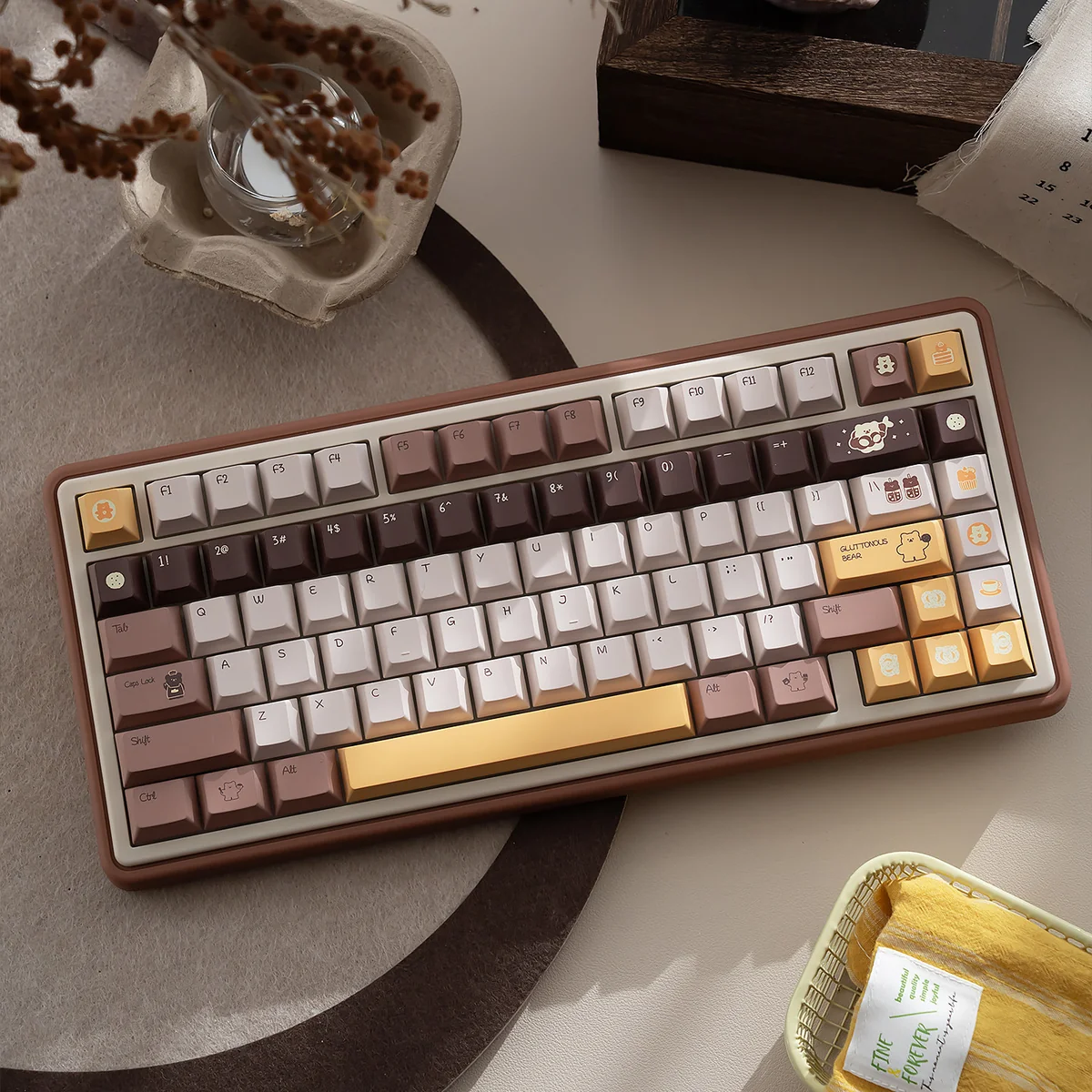 Adorable Butter Bear mechanical keyboard, tri-mode , with vibrant RGB backlighting on a warm hues desk setup.