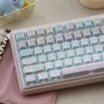 Playful tri-mode mechanical keyboard with adorable puppy motifs, captured from a side angle, revealing its soft pastel colors and glowing RGB effects.