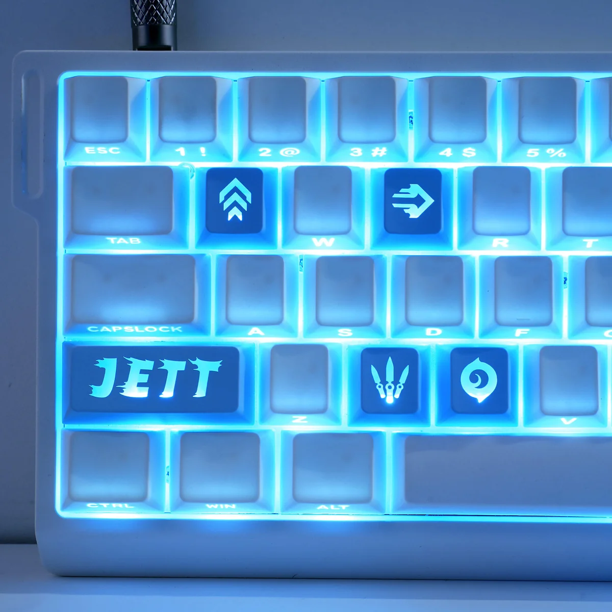 Close-up views of translucent Valorant: Agent's Skill Supplement Keycap Set, featuring crisp, colorful agent ability icons from various angles, bringing playful PC gaming setup.