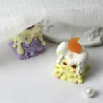 A whimsical 'Weaver of Light' resin artisan ESC keycap, handcrafted with vibrant yellow and purple ethereal details, showcasing its unique design.