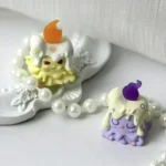Whimsical 'Weaver of Light' resin artisan keycap, handcrafted with ethereal yellow and purple accents, showcasing its unique and playful design.