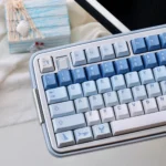 Ethereal Whale Dream PBT Keycaps Set shown from multiple artistic angles, highlighting the tranquil whale and cloud designs. Durable PBT.