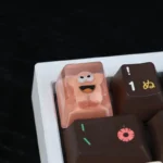 Close-up of a whimsical handcrafted resin artisan keycap, showing the unique big mouth star character from a side angle, highlighting its artistic design.