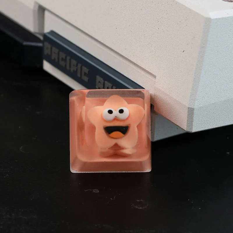 Whimsical handcrafted Big Mouth Star resin artisan keycap, shown from an artistic angle, highlighting its unique five-pointed star design and quirky.