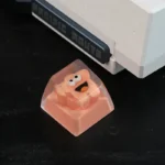 A unique handcrafted whimsical big mouth star resin artisan keycap, showcasing its quirky design and intricate details from various artistic angles.