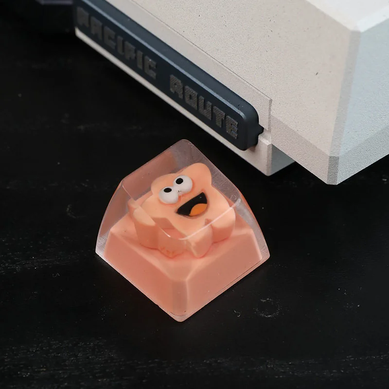 A unique handcrafted whimsical big mouth star resin artisan keycap, showcasing its quirky design and intricate details from various artistic angles.