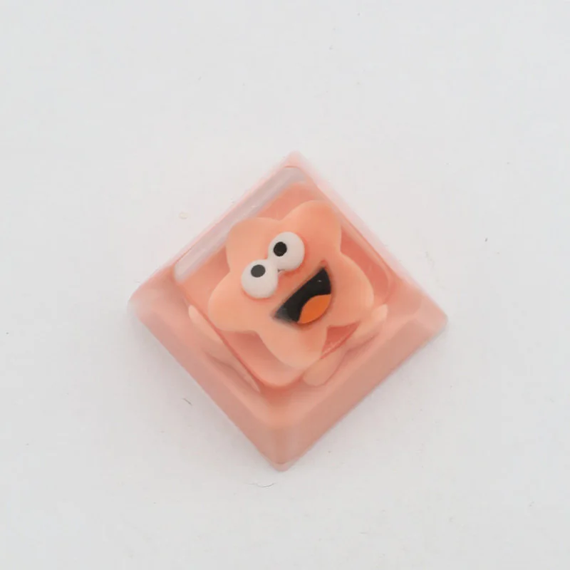 Close-up of a whimsical Big Mouth Star resin artisan keycap, showcasing its unique handcrafted details and quirky five-pointed star design.