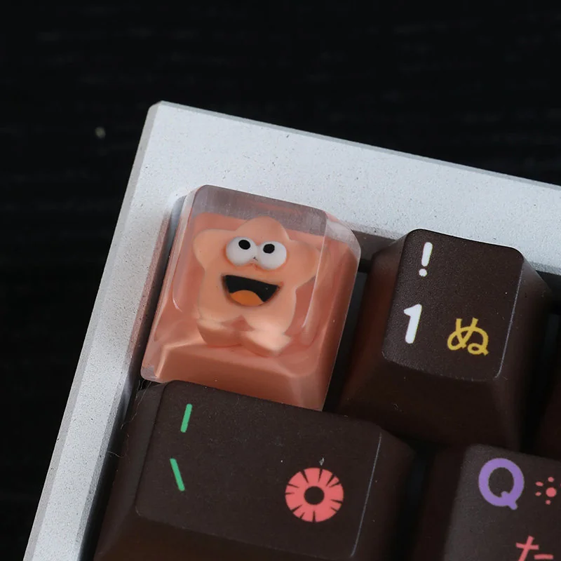 Vibrant, handcrafted whimsical big mouth star resin artisan keycap, showcasing its unique, quirky design.