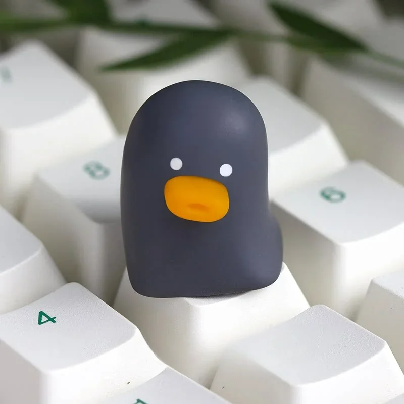 This gallery image features a delightful top-down view of the whimsical artisan resin duck keycap, emphasizing its smooth texture and charming, vibrant design.
