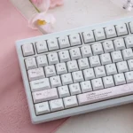 Close-up of a Yier & Bubu PBT dye-sublimated keycap set, revealing the whimsical character art and vibrant, long-lasting legends from a unique angle.