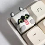 A detailed side view of the handcrafted Zenless Zone Zero Bangboo artisan keycap, highlighting its vibrant 3D sculpt and game-accurate details.
