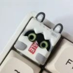Multiple angles of the handcrafted Zenless Zone Zero Bangboo artisan keycap, showcasing its vibrant 3D sculpted details and playful pose.